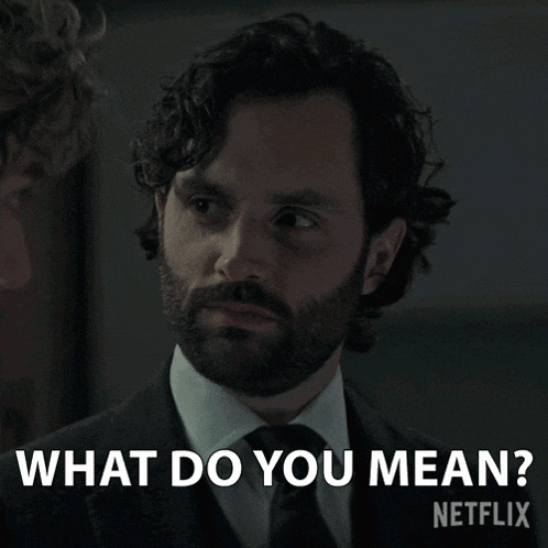 a man in a suit and tie asks what do you mean