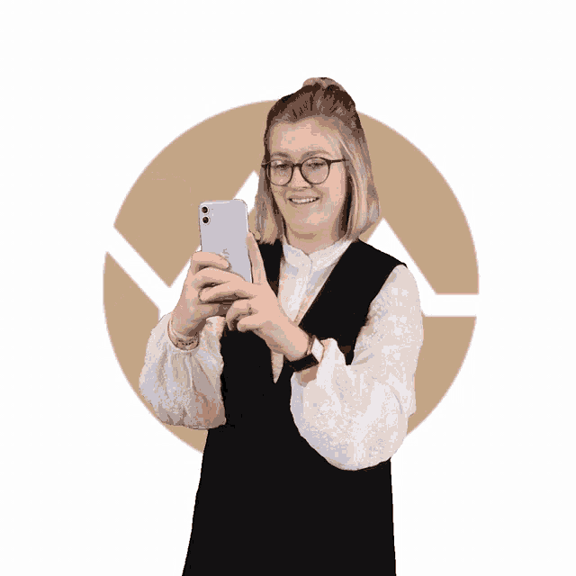 a woman wearing glasses holds a cell phone in her hand