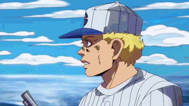 a man in a baseball cap is holding a gun in his hand .