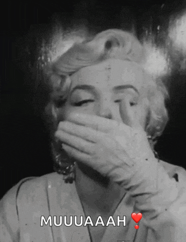 a black and white photo of a woman covering her mouth with her hand and the words muuuaah below her