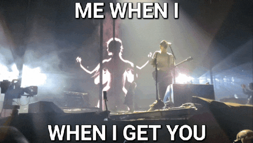 a man playing a guitar on a stage with the words me when i when i get you