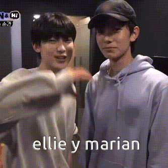 two young men are standing next to each other and one of them is pointing at the camera with the words ellie y marian on the bottom