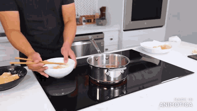 a man is cooking on a stove with the words made in animatica visible