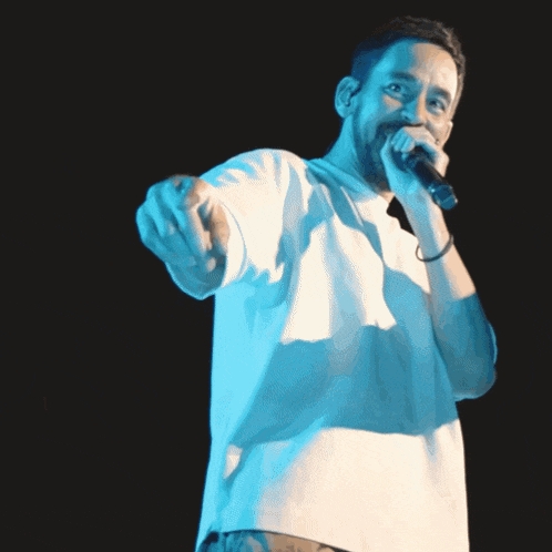 a man singing into a microphone with yo in red
