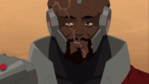 a man with a beard wearing a helmet looks at the camera