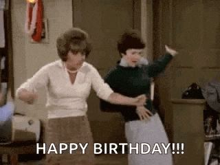 two women are dancing in a room and one of them is saying happy birthday .
