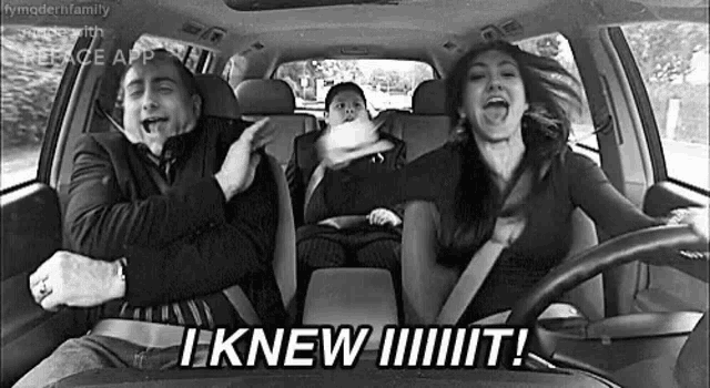 a black and white photo of a man , woman and child driving a car .
