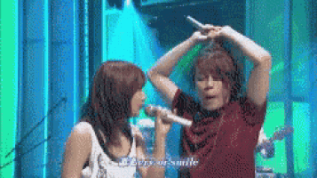 a man and a woman singing into microphones with the words berry of smile visible