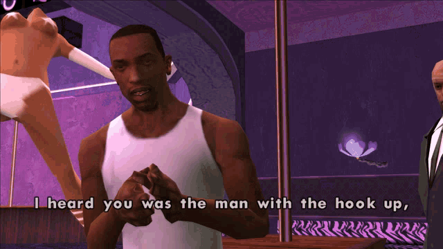 a man in a white tank top is talking to another man in a purple room