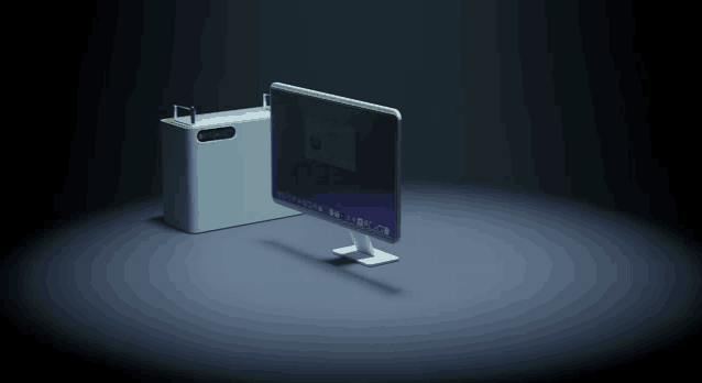 a computer monitor is sitting next to a white box that says ' macbook pro ' on it