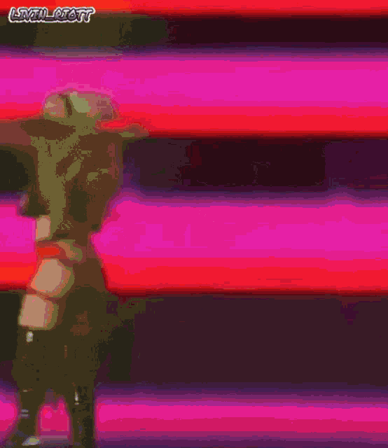 a woman in a wrestling outfit is walking down a red aisle .
