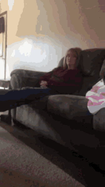a woman sitting on a couch with her legs crossed