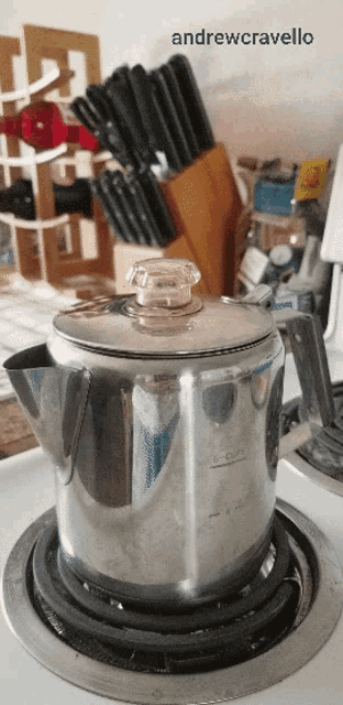 a picture of a coffee pot on a stove with the name andrew cravello written above it
