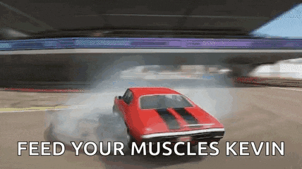 a red car is driving under a bridge with the words feed your muscles kevin above it