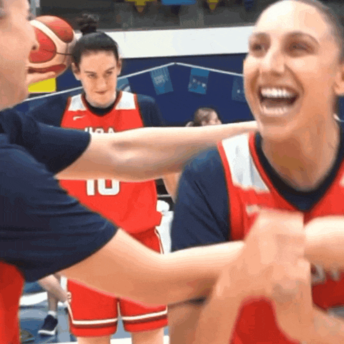 a female basketball player wearing a red jersey with the number 10