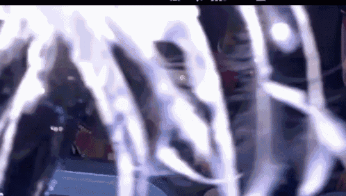 a blurred image of a person standing in front of a fountain