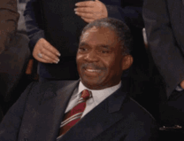 a man in a suit and tie has the words that 's a penis written on his face