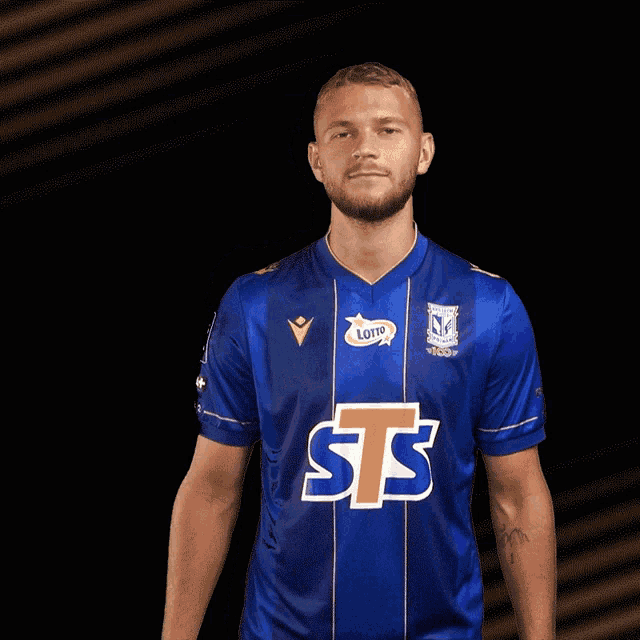 a man wearing a blue shirt with sts on the front