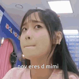 a girl with long hair is making a funny face and saying pov eres d mimi .