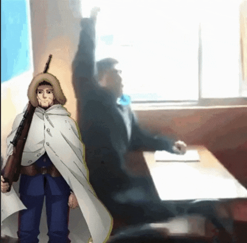 a man with a rifle is raising his hand in a classroom while another man sits at a desk in the background .