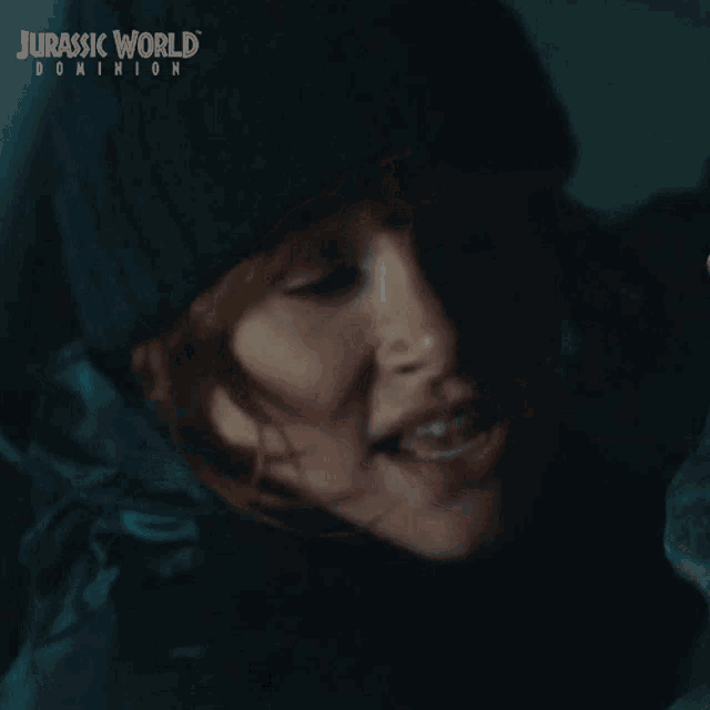 a woman in a beanie is making a funny face and says yeah