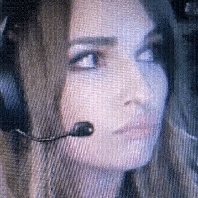 a woman is wearing headphones and a microphone .