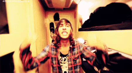 a man wearing a plaid shirt and a beanie with the word americana on the bottom