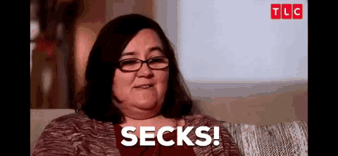 a woman wearing glasses is sitting on a couch and saying socks .