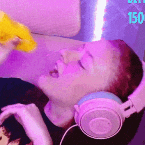 a woman wearing headphones is eating a yellow item with the number 150 in the background