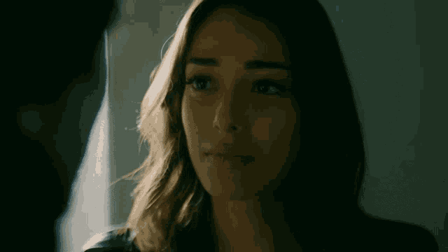 a close up of a woman 's face with a serious look on her face
