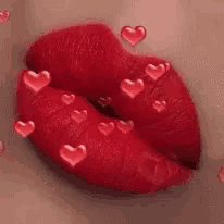a close up of a woman 's red lips with hearts surrounding them .