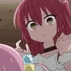 a girl with red hair and green eyes is looking at herself in the mirror .