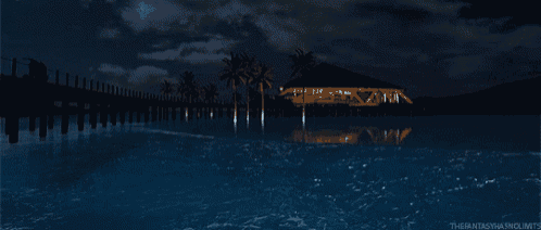 a beach scene at night with palm trees and a dock in the foreground