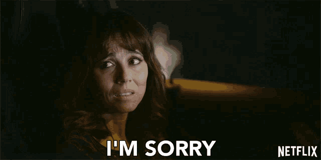 a woman in a car is saying i 'm sorry