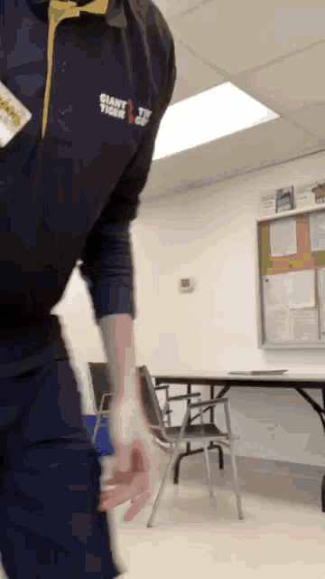 a man wearing a giant tiger shirt stands in a room