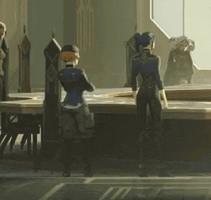 a group of people are standing around a table in a room in front of a window .