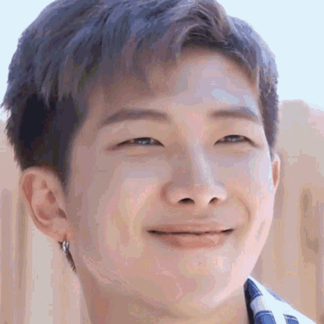 a close up of a person 's face with a smile on their face .