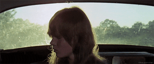 a woman looks out the window of a car with the words idle experience on the bottom right