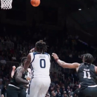 a basketball player wearing a number 0 jersey throws the ball