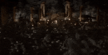a blurred image of a group of people sitting around a table with candles