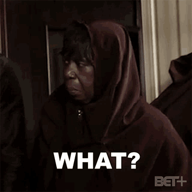 a woman in a hooded jacket is making a funny face and asking what .