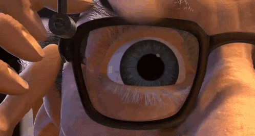 a close up of a person 's eye wearing glasses .