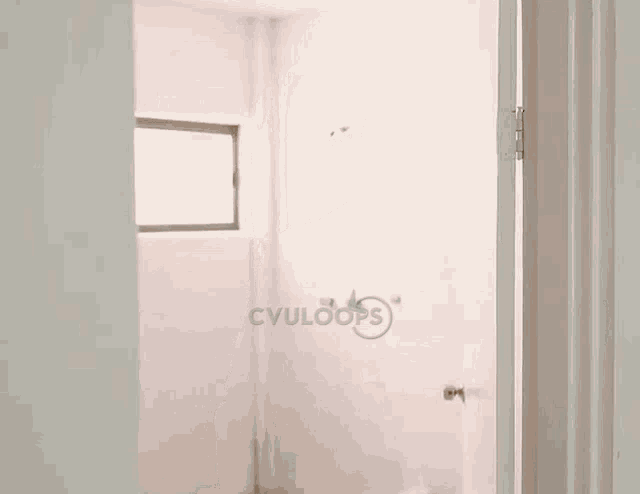 a man is peeking out of a doorway in a bathroom with cvuloops written on the wall behind him