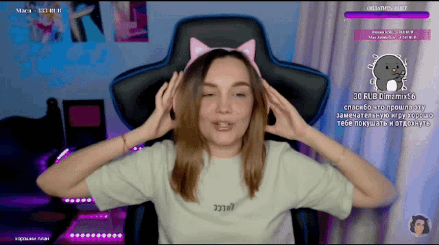 a woman wearing a cat ear headband sitting in a chair