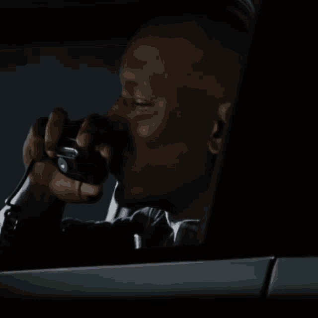 a man in a car is talking on a cellphone