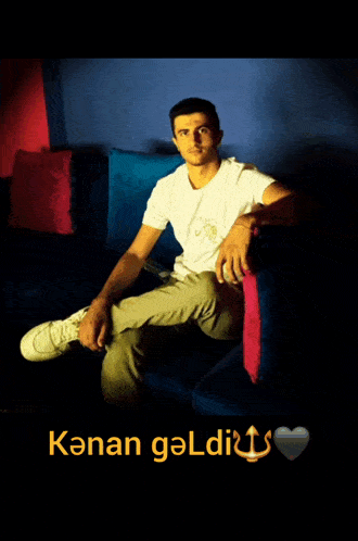 a man in a white shirt sits on a blue couch with the words konan geldig written on the bottom