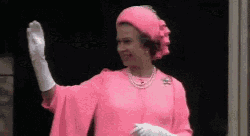 the queen is wearing a pink dress , hat , and gloves and waving .