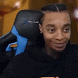 a man is sitting in a black and blue gaming chair .