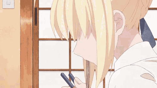 a girl is sitting at a table eating food with chopsticks .