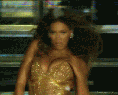 a blurry picture of a woman in a gold dress with beyonceblue written in the corner